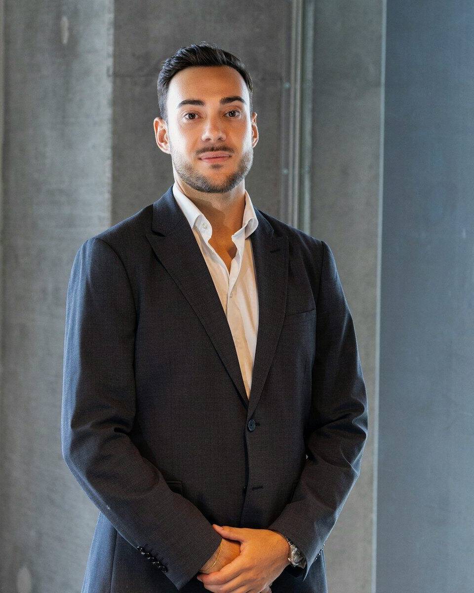 a man in a suit standing in a room